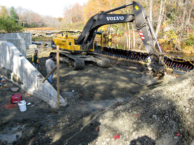 Installation of earthen embankment with low permeability soil